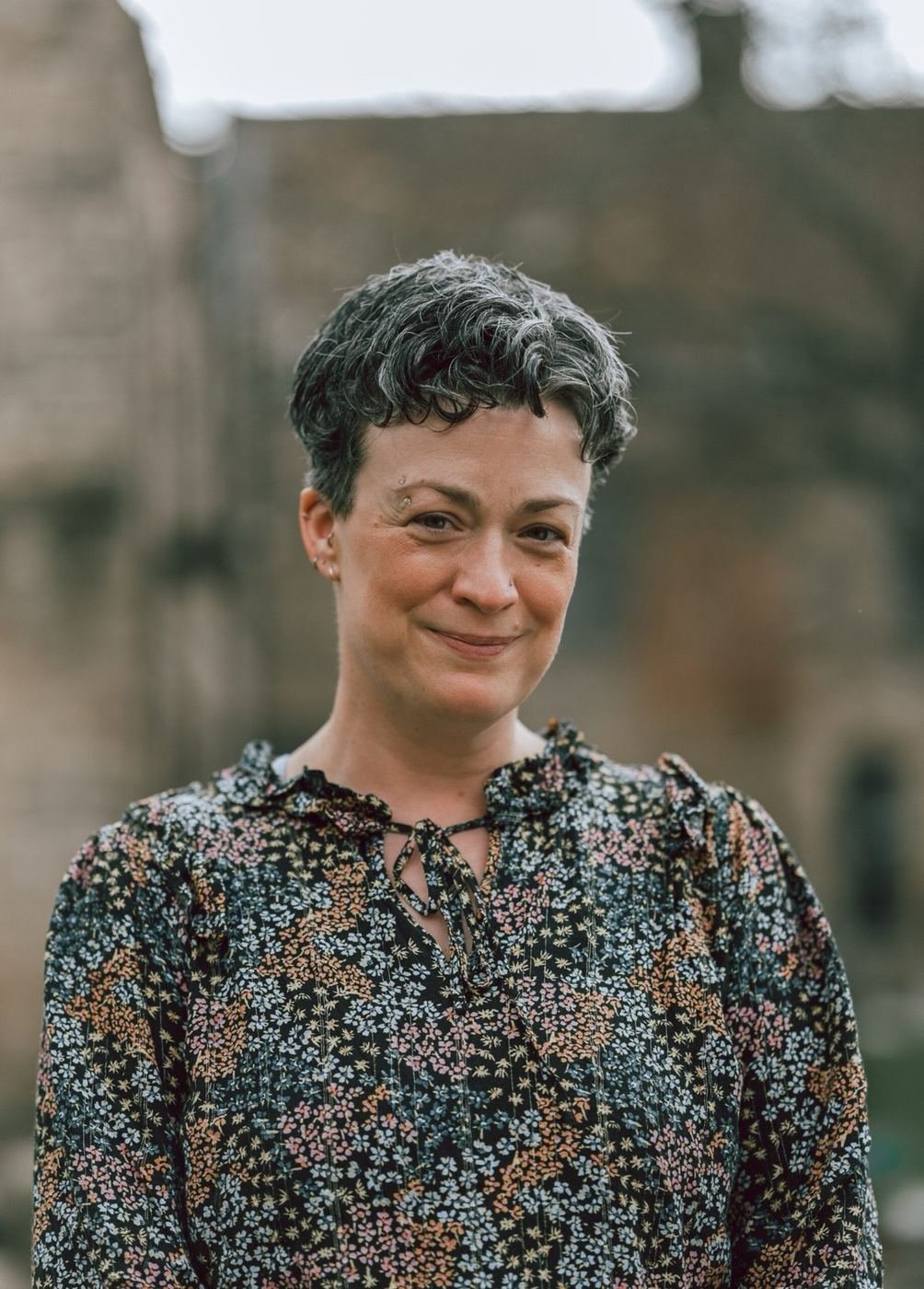 Portrait of Kate in a flowery blouse, smiling